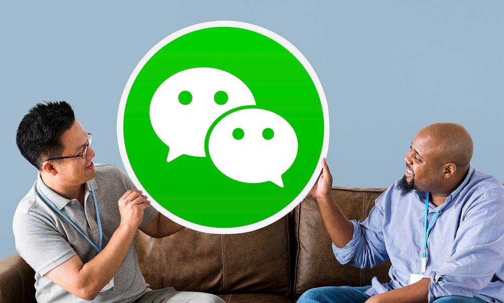 Men showing a WeChat icon
