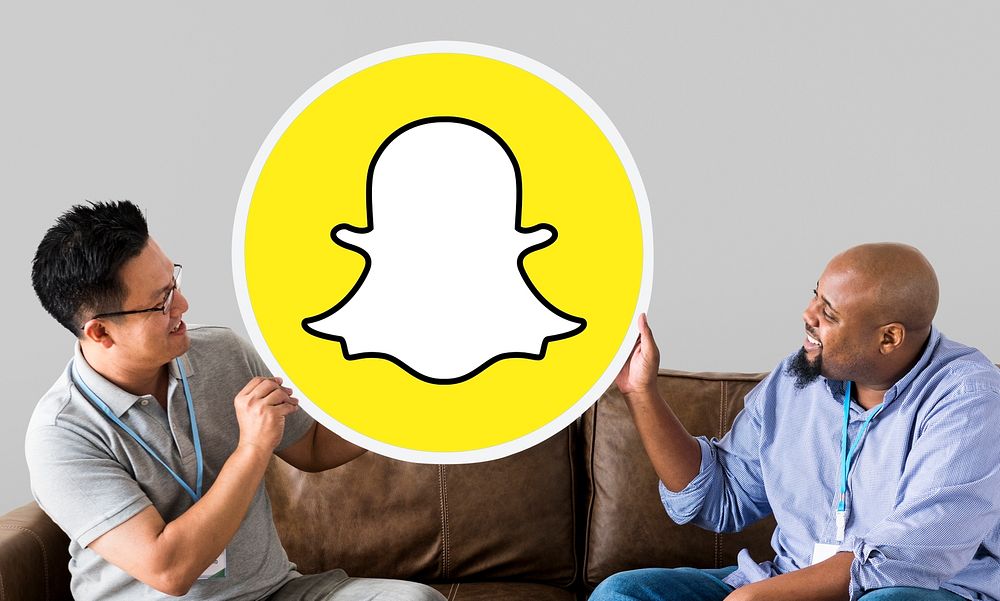 Men showing a Snapchat icon