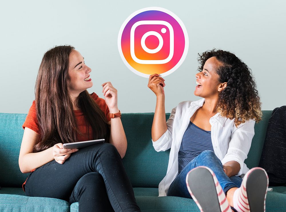 Young women showing an Instagram icon