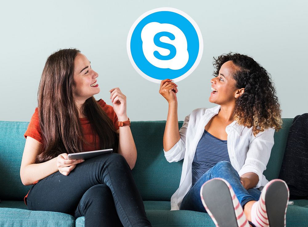 Young women showing a Skype icon