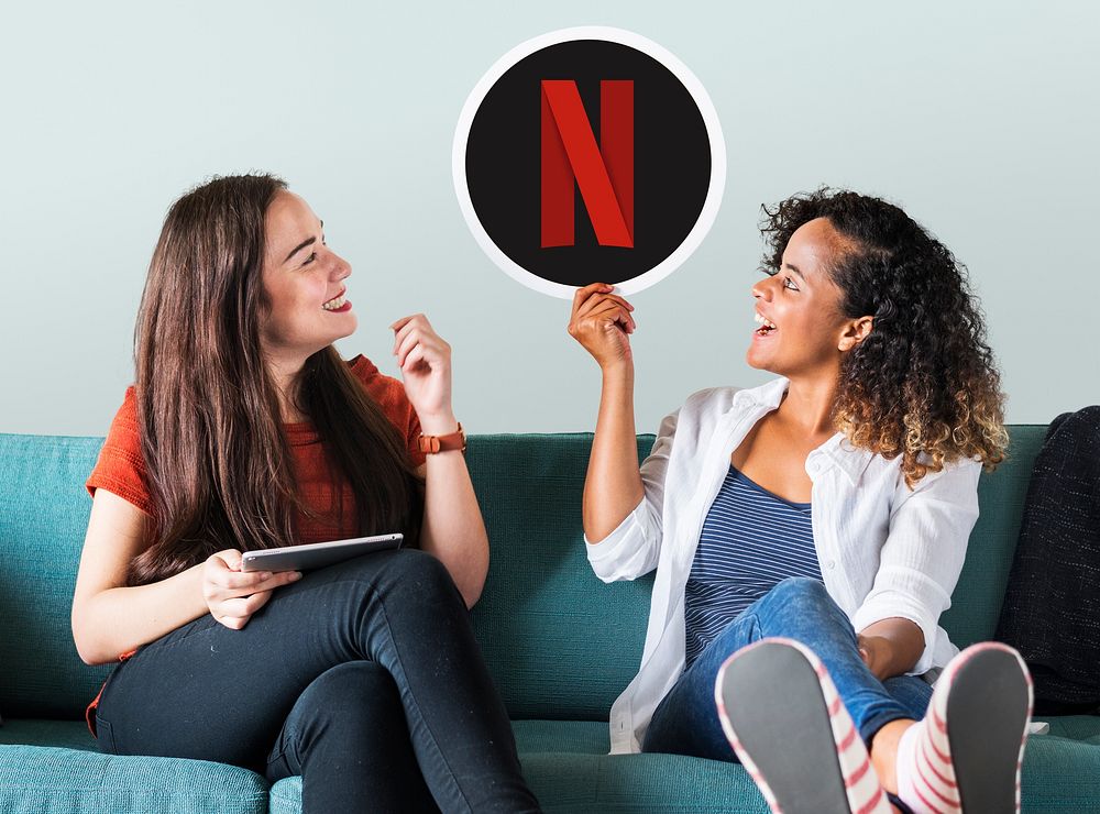 Young women showing a Netflix icon
