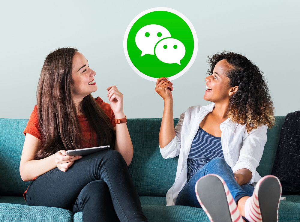 Young women showing a WeChat icon