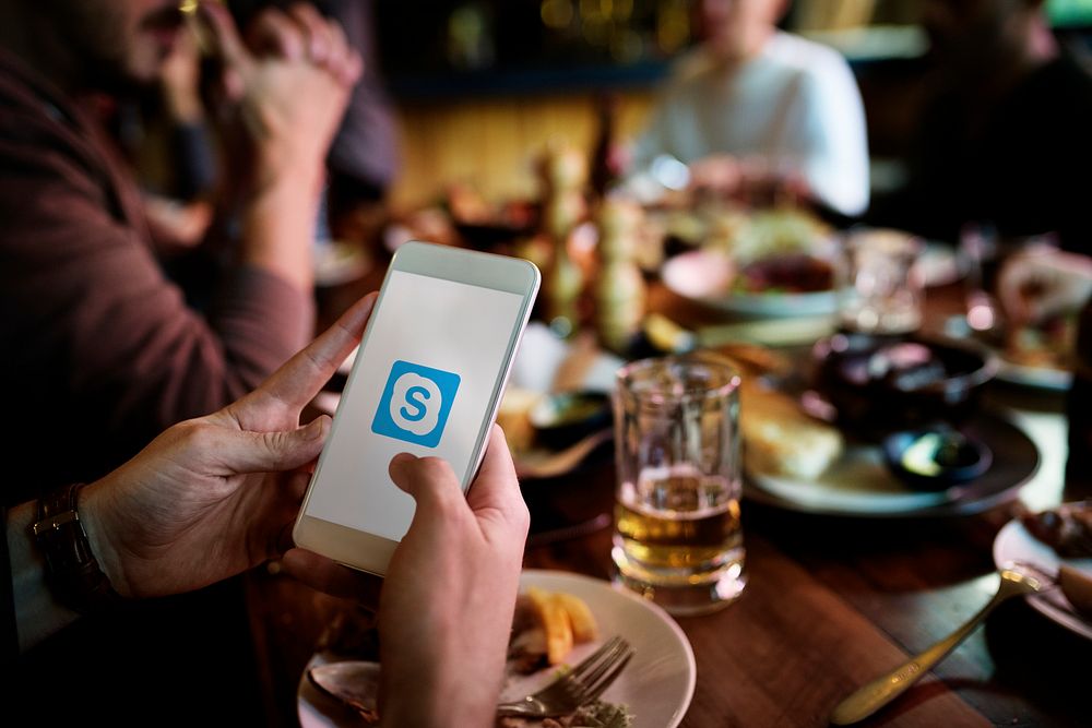 A person using Skype application in a restaurant. BANGKOK, THAILAND, 1 NOV 2018.