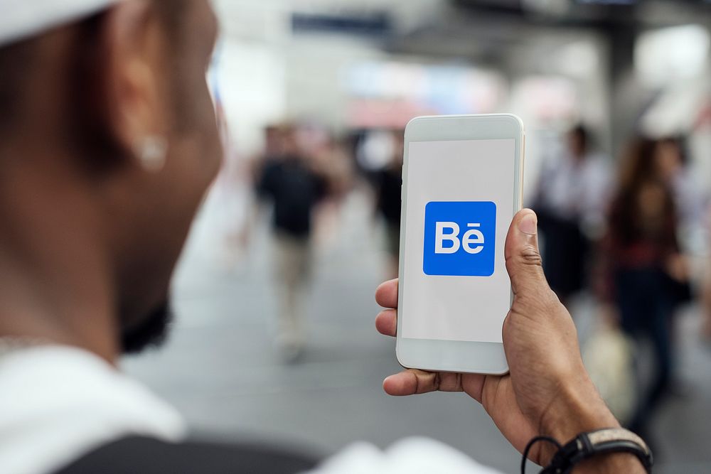 A person using Behance on a smartphone. BANGKOK, THAILAND, 1 NOV 2018.