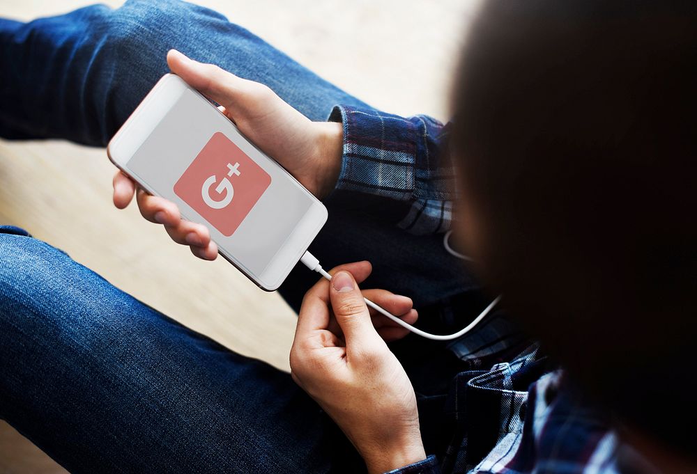 A woman using Google Plus application on a mobile phone. BANGKOK, THAILAND, 1 NOV 2018.