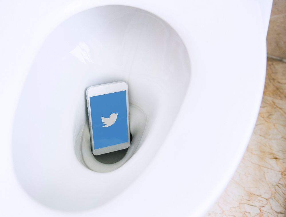 Twitter logo showing on a phone in a toilet bowl. BANGKOK, THAILAND, 1 NOV 2018.