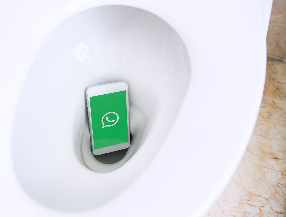 Whatsapp logo showing on a phone placed in a toilet bowl. BANGKOK, THAILAND, 1 NOV 2018.