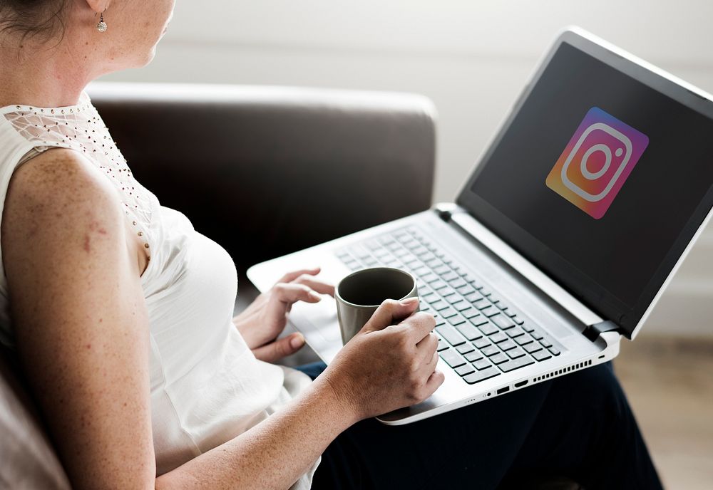Woman using Instagram application on her laptop