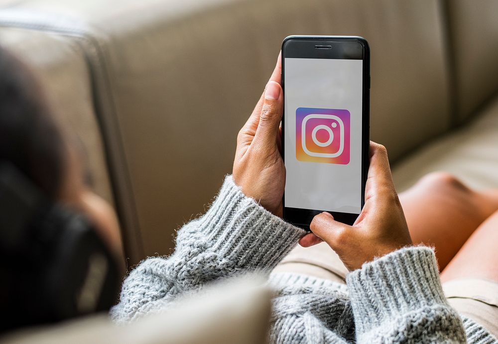 Woman using Instagram while listening to music at home. BANGKOK, THAILAND, 1 NOV 2018.