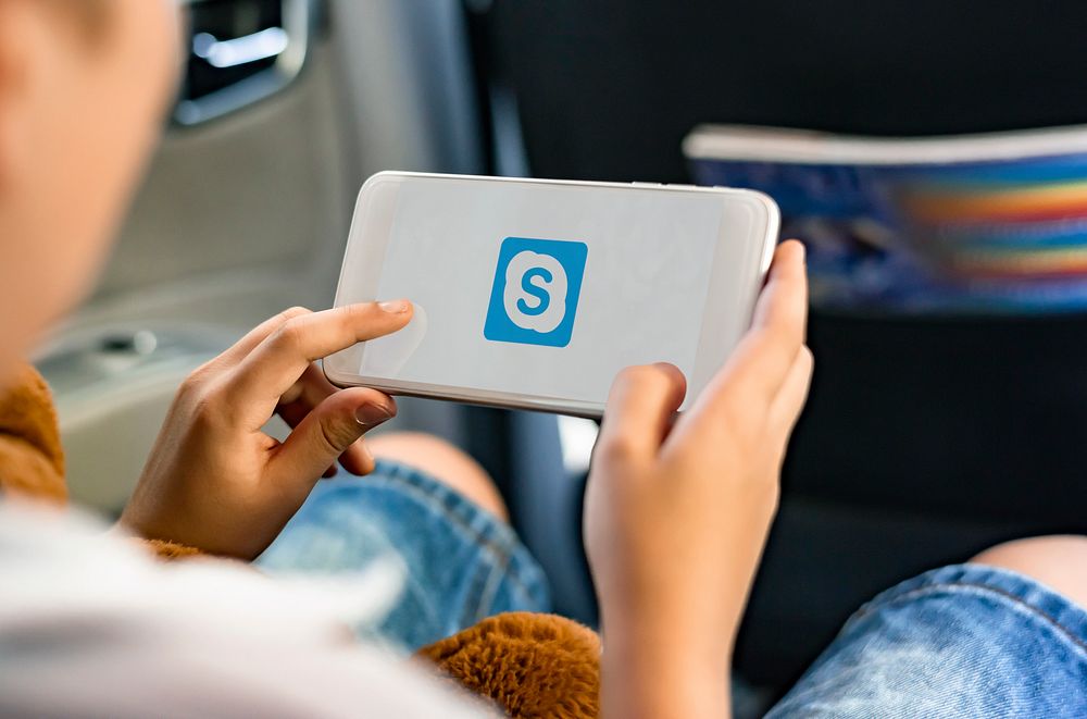 Young boy  using application on a phone in a car. BANGKOK, THAILAND, 1 NOV 2018.