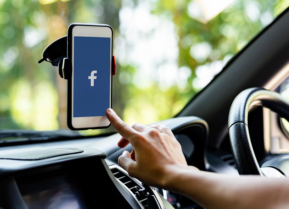 Person using Facebook application on a phone in a car. BANGKOK, THAILAND, 1 NOV 2018.