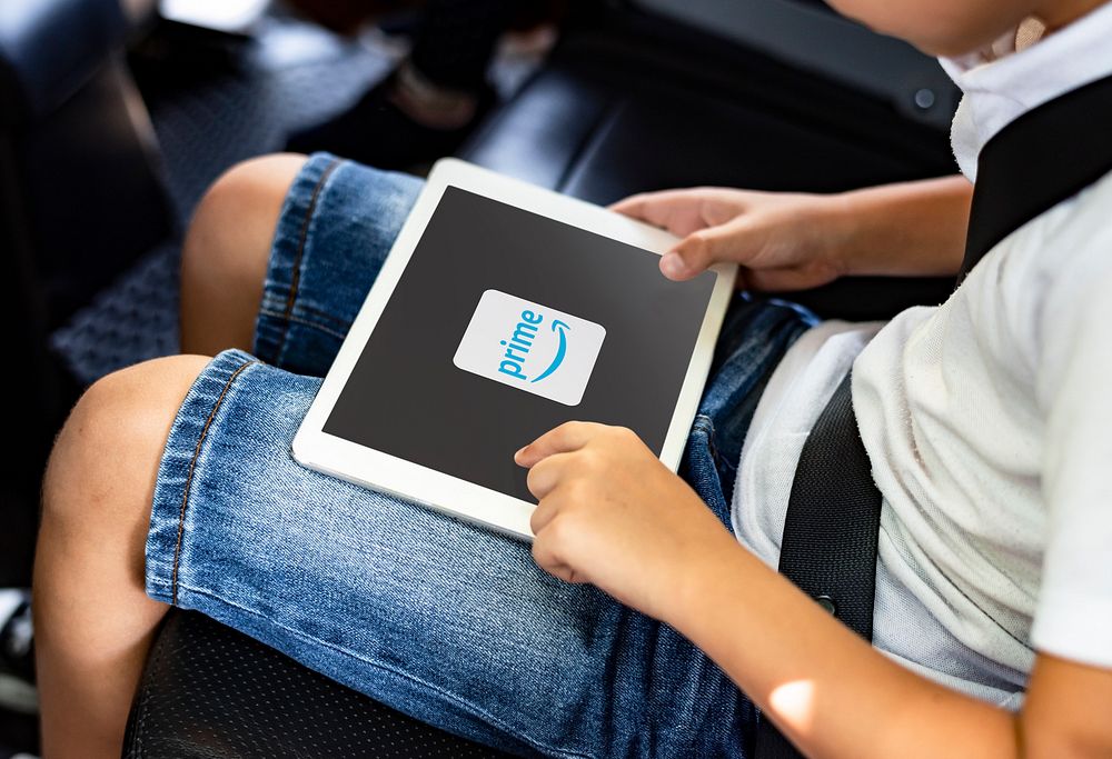 Boy watching Prime Video on a digital tablet in the car. BANGKOK, THAILAND, 1 NOV 2018.