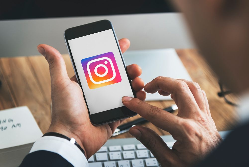 Businessman using Instagram application in an office. BANGKOK, THAILAND, 1 NOV 2018.