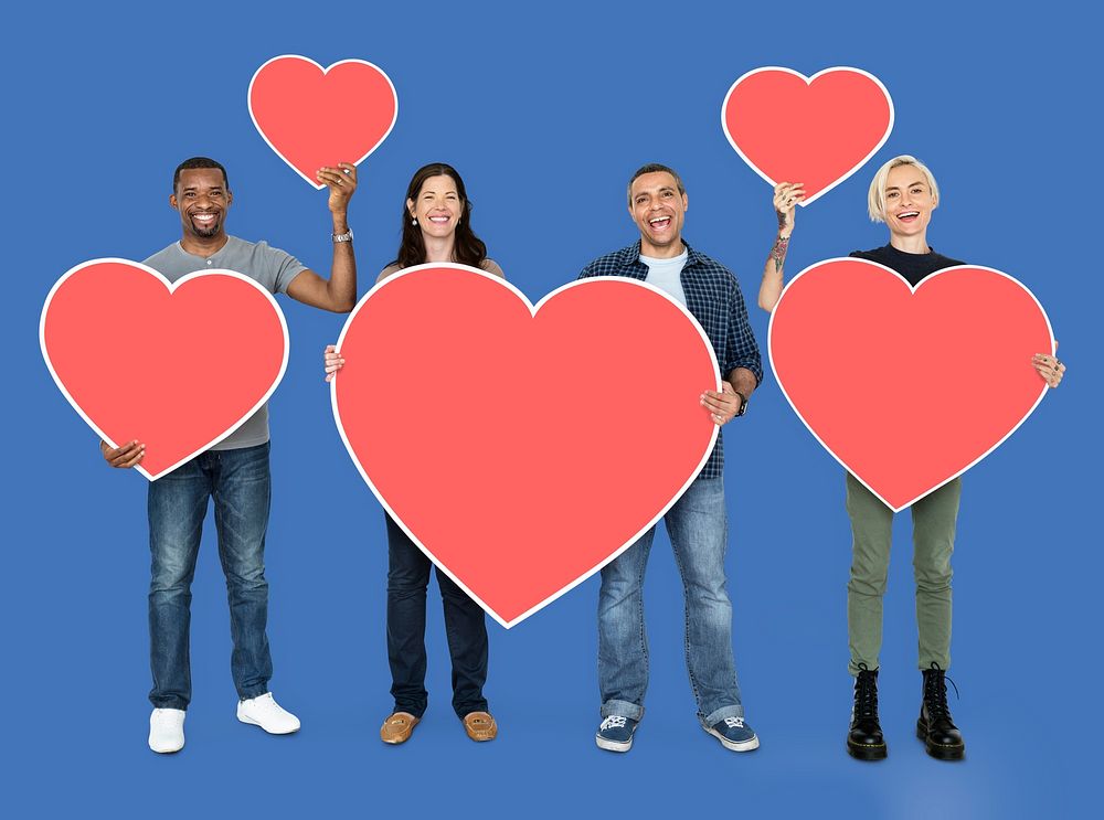 Diverse people holding heart shaped icons