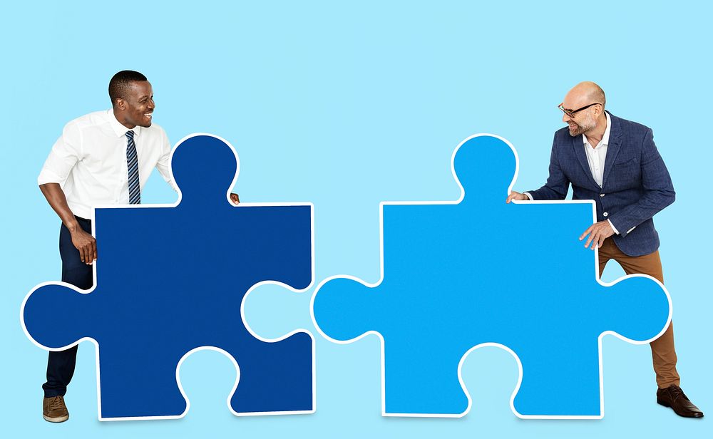 Two men connecting puzzle pieces
