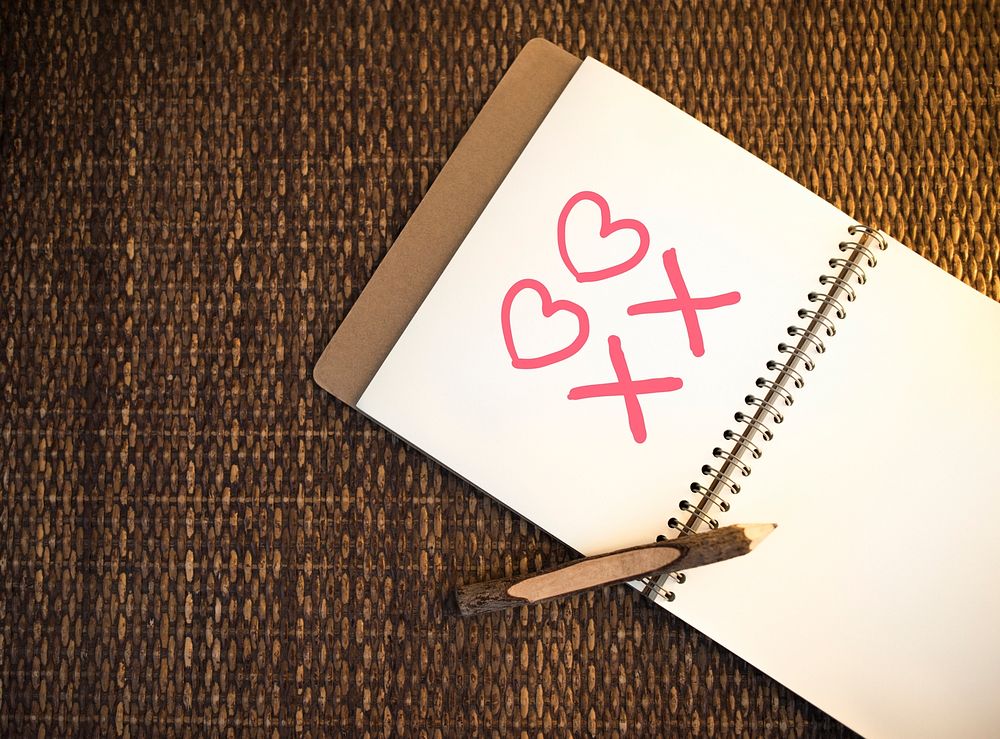 Heart and kiss symbols drawn on a notebook