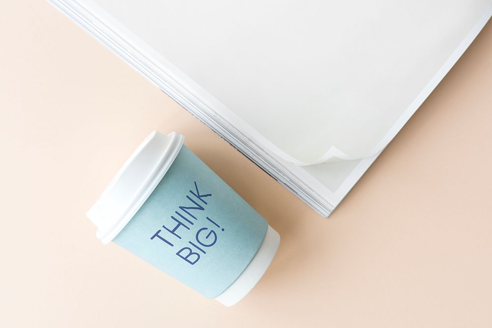 Think big written on a paper cup