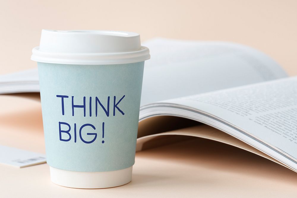 Think big written on a paper cup
