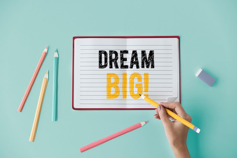 Hand writing Dream big on a notebook