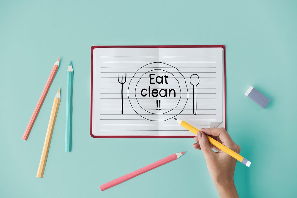 Hand writing Eat clean on a notebook