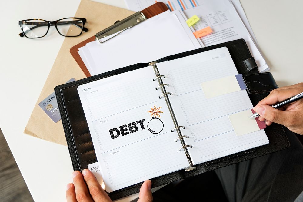 Woman writing down her financial debts