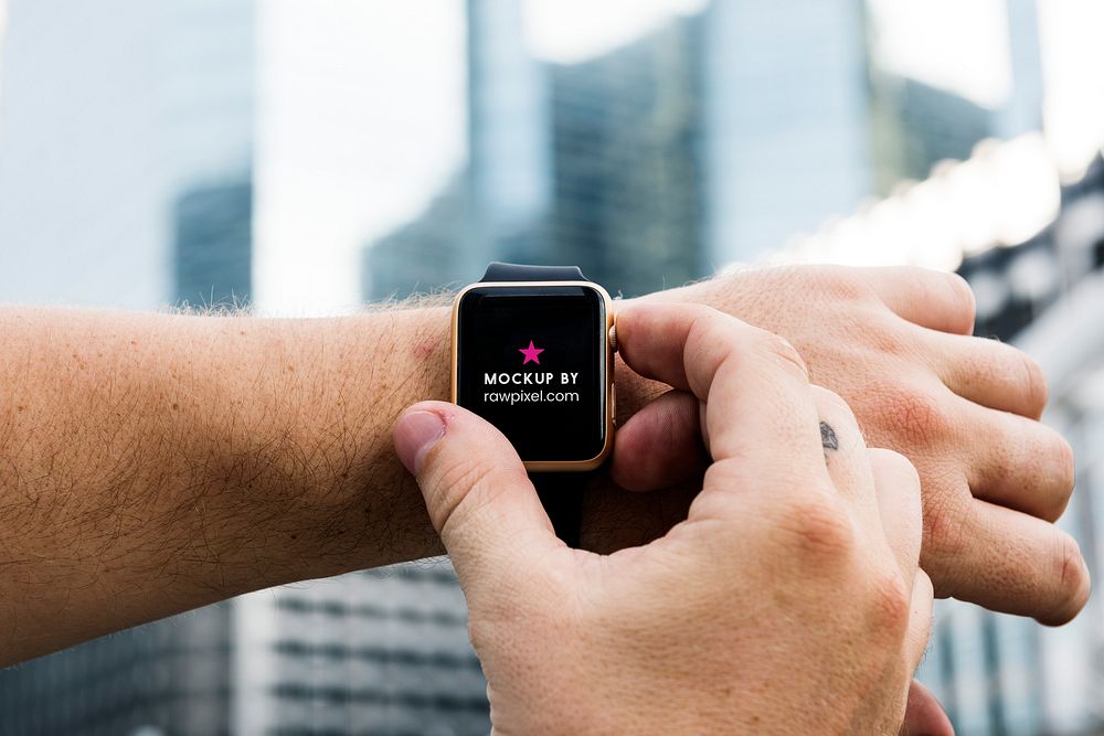 A digital watch worn by a man outdoors