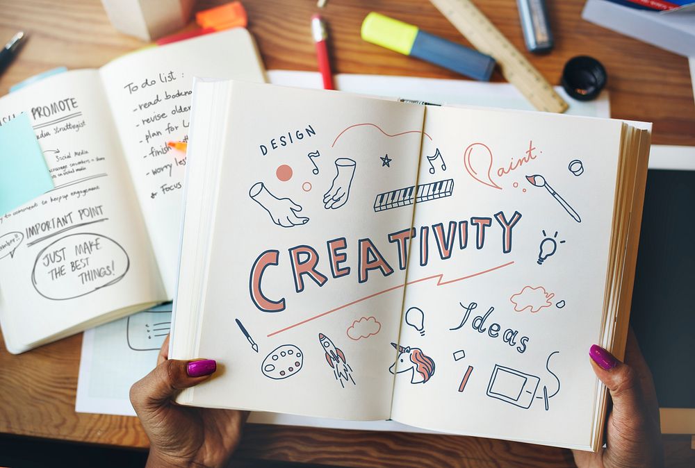 Woman reading about creativity from a book