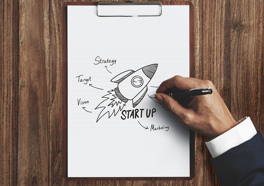 Businessman drawing a startup plan