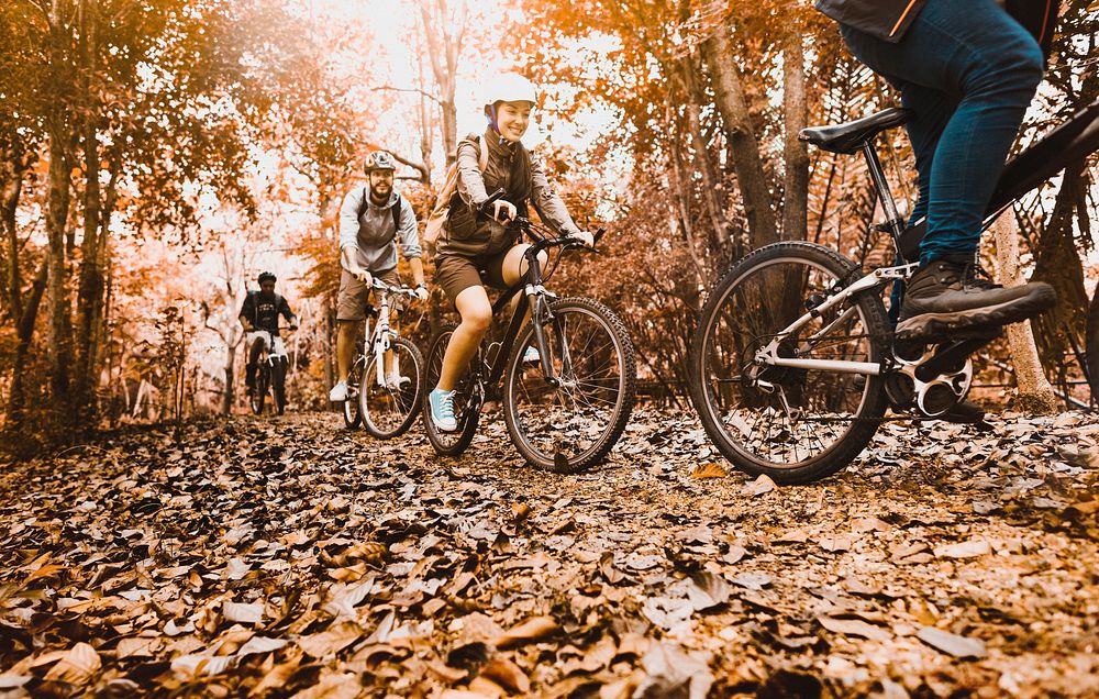 Adventure desktop wallpaper background, people riding mountain bikes in the woods, warm tone