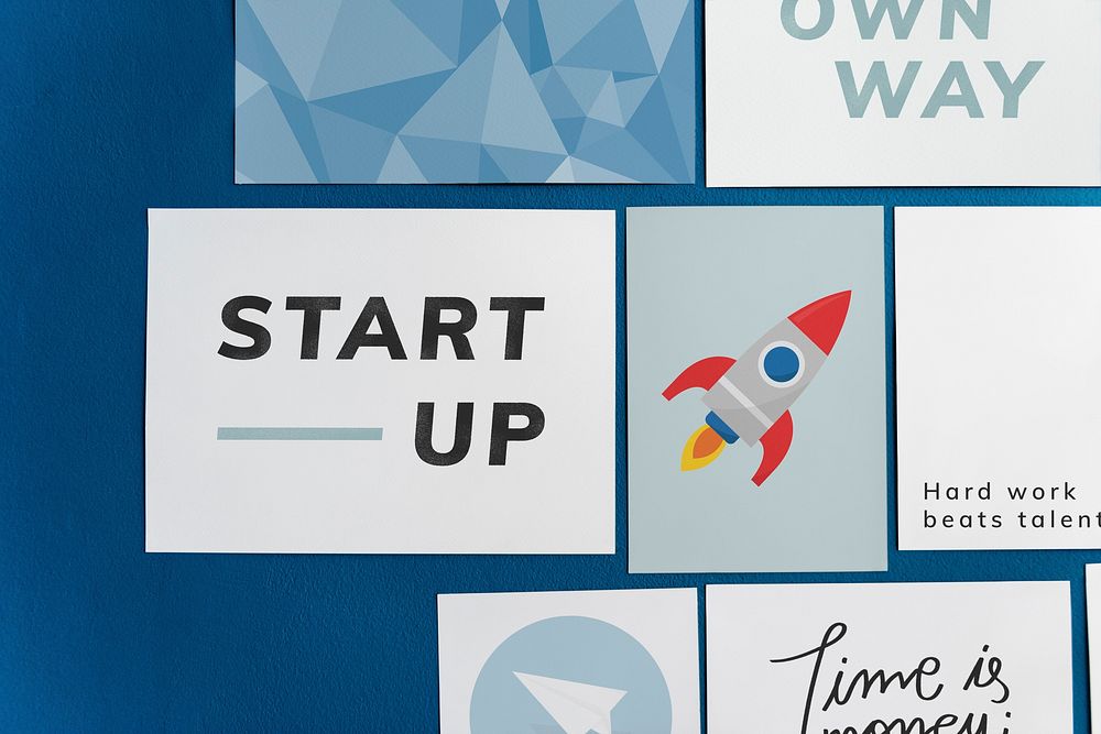 Startup card set on a blue wall