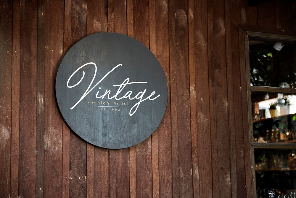 Black sign on a wooden wall mockup