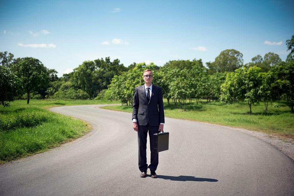 Businessman standing on a road