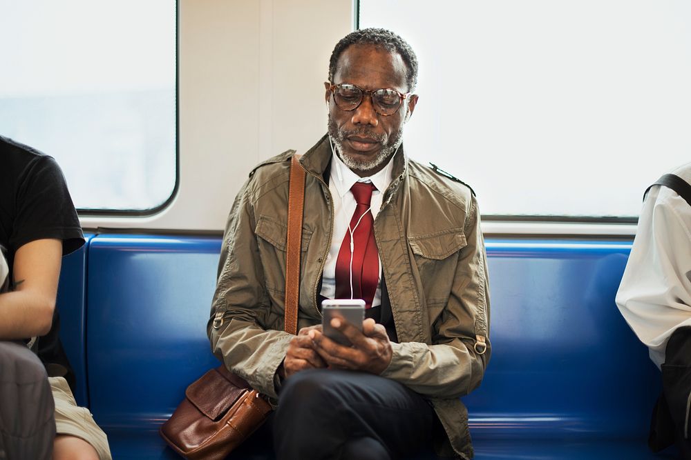 African descent businessman is using earphones