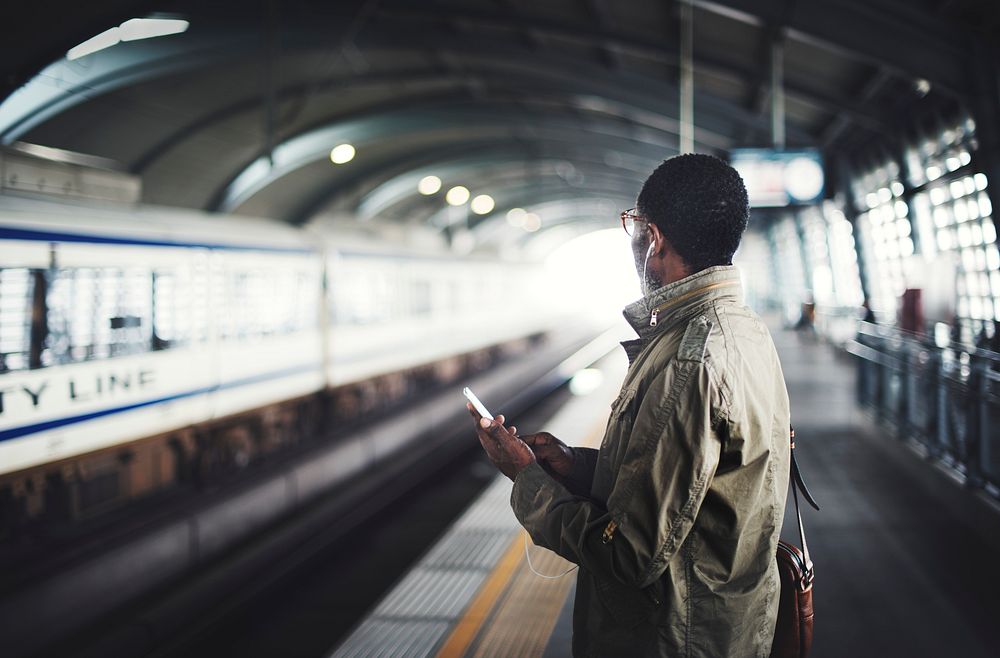 Black man waiting for a train on the platform