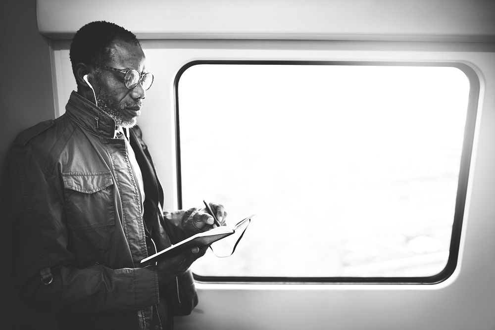 Businessman writing while on the subway