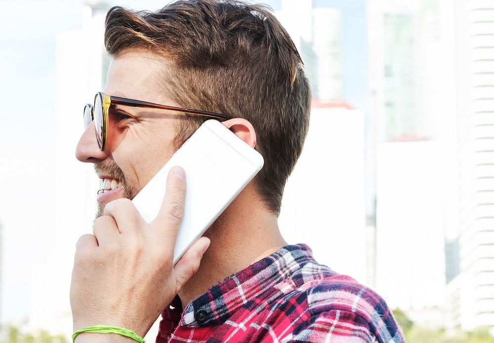Young Man Outdoors Talking Smartphone Concept