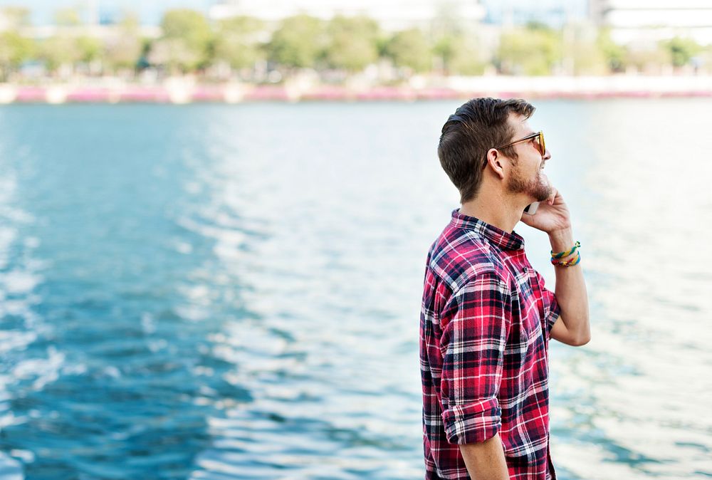 Young Man Outdoors Talking Smartphone Concept