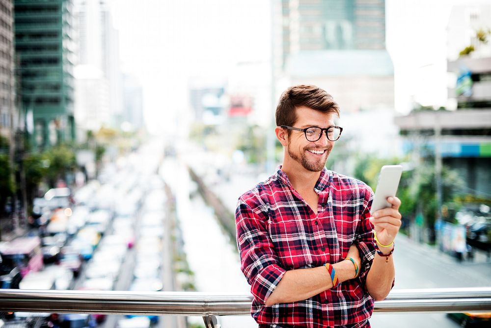Young Man Outdoors Browsing Smartphone Concept