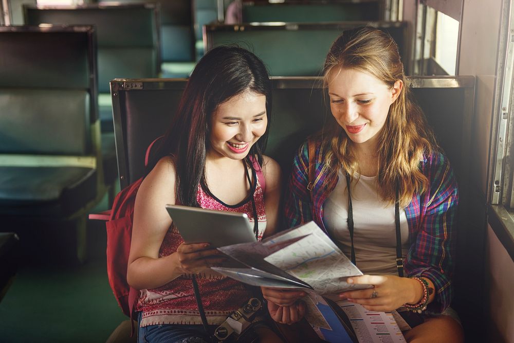 Young tourists are riding a train