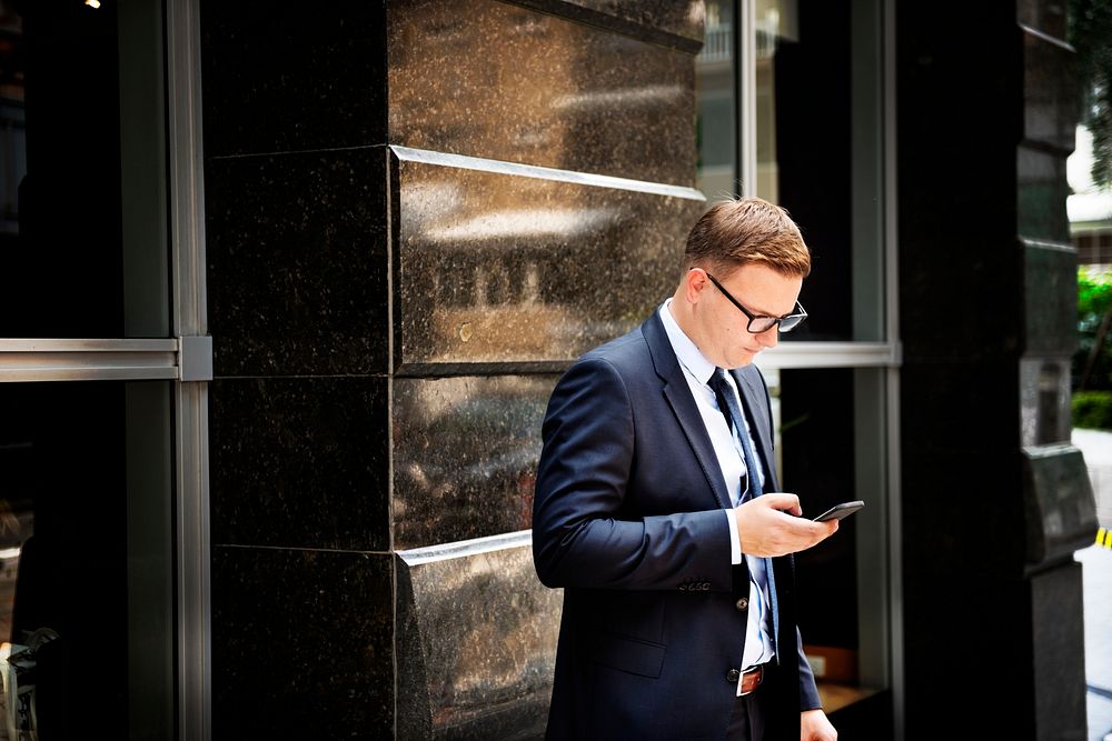 Businessman standing using mobile phone