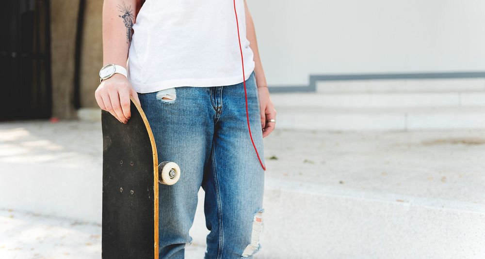 Person with skateboard standing outdoor