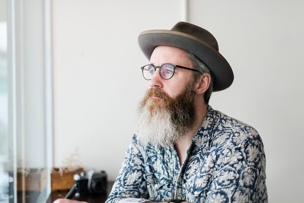 Bearded man alone in a coffee shop