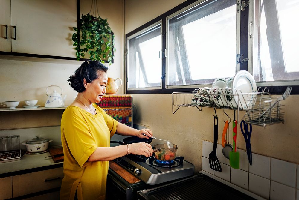 Asian woman is cooking in the kitchen