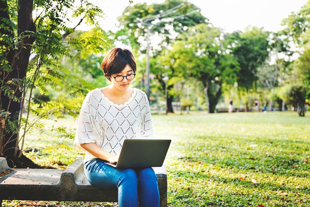 Woman Sitting Typing Laptop Park Concept