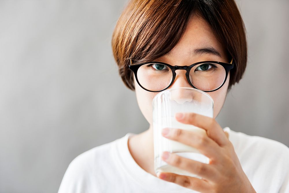 Asian Girl Drinking Milk Beverage Grow Up Relaxation Concept