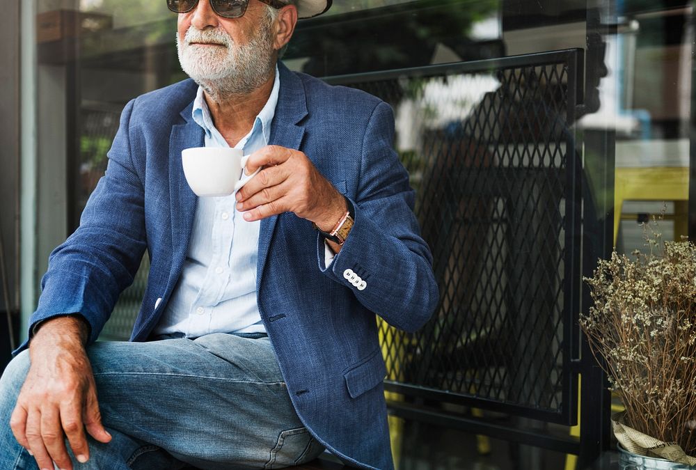 Elderly man is enjoying a coffee