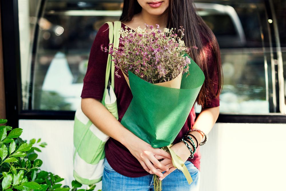 Woman carrying a bouquet of flowers