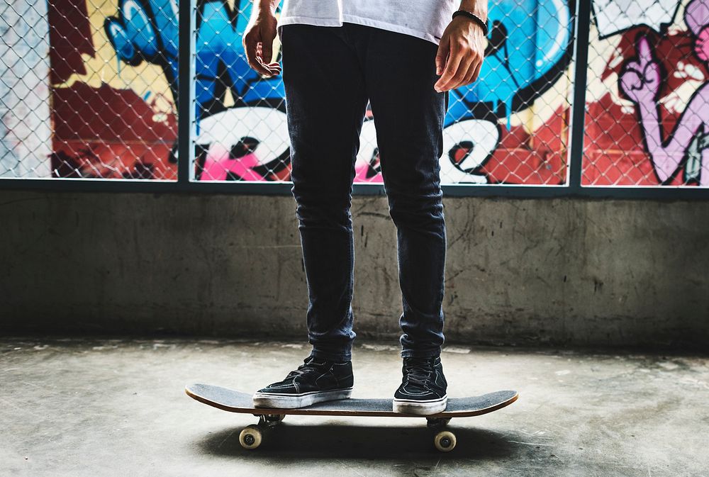 Legs standing on skateboard