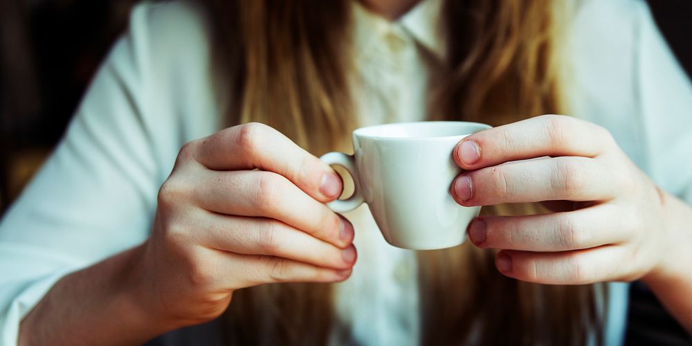 Closup of woman hands holding coffee cup