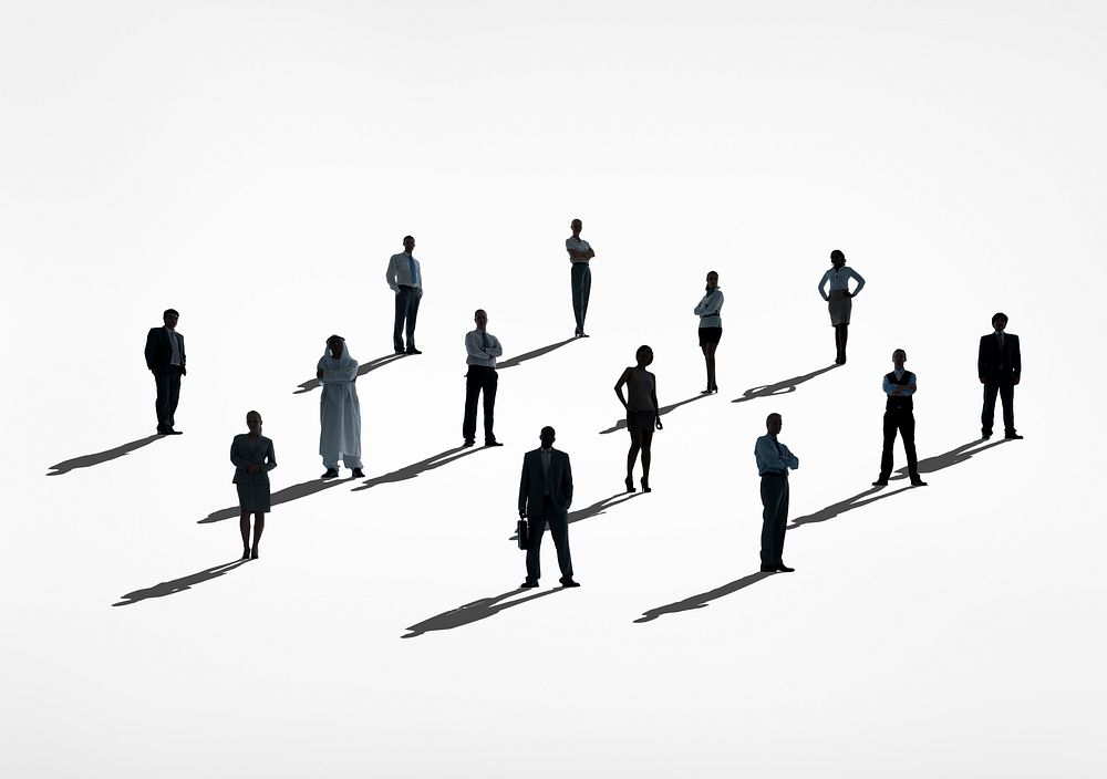 Silhouettes of multi-ethnical business people standing in a white background.